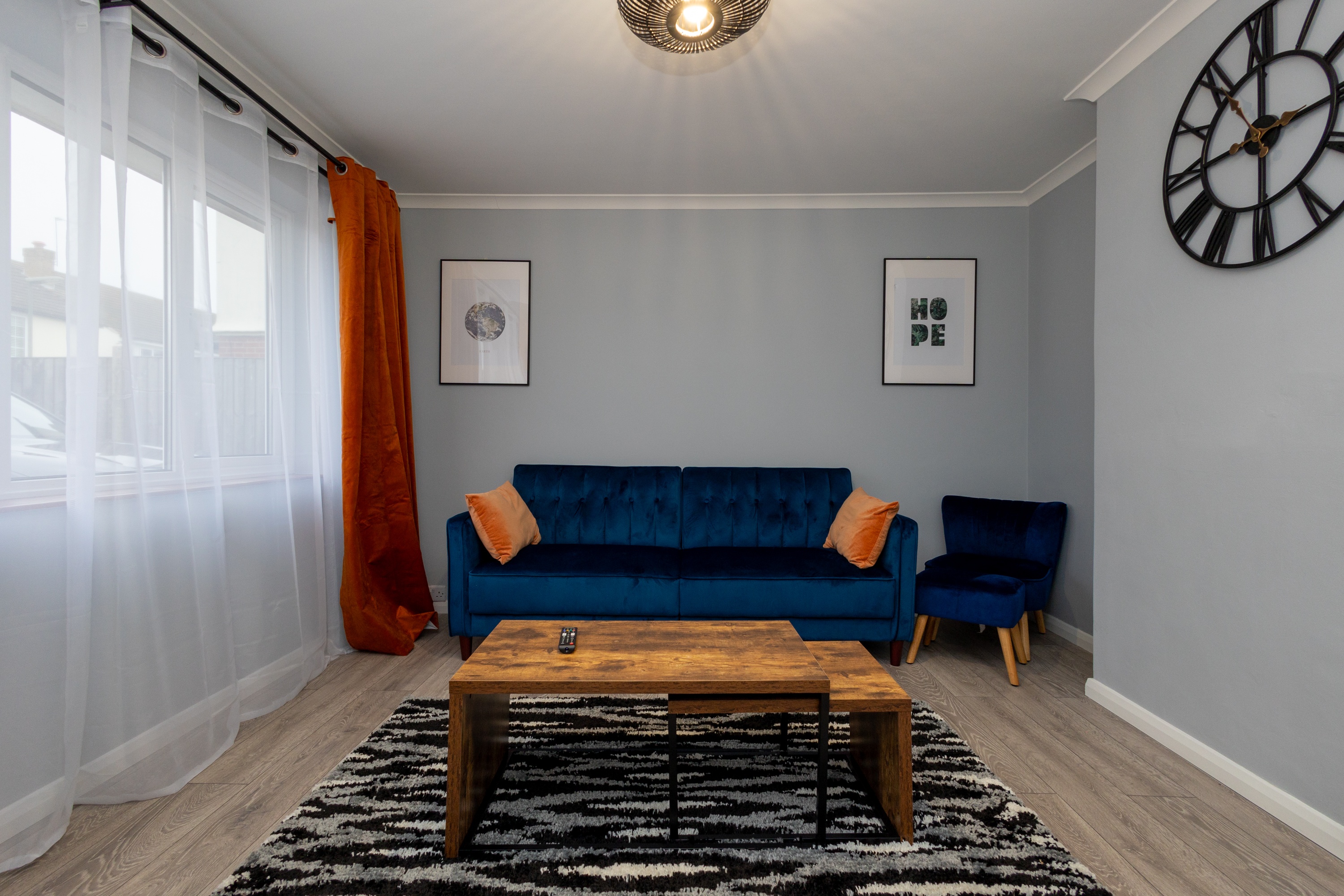 Bright ThreePoints living room with a blue sofa